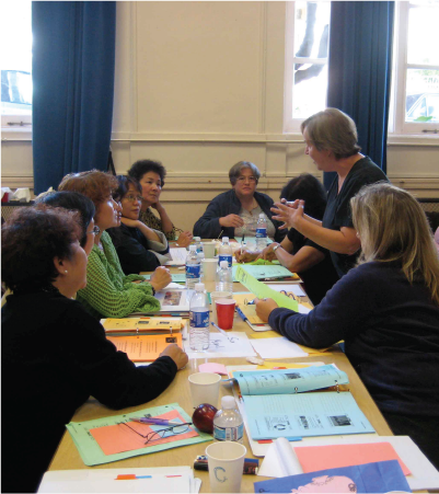 Group of adults listening to an instructor around a table