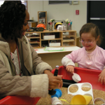 Teacher and Student interacting at activity table